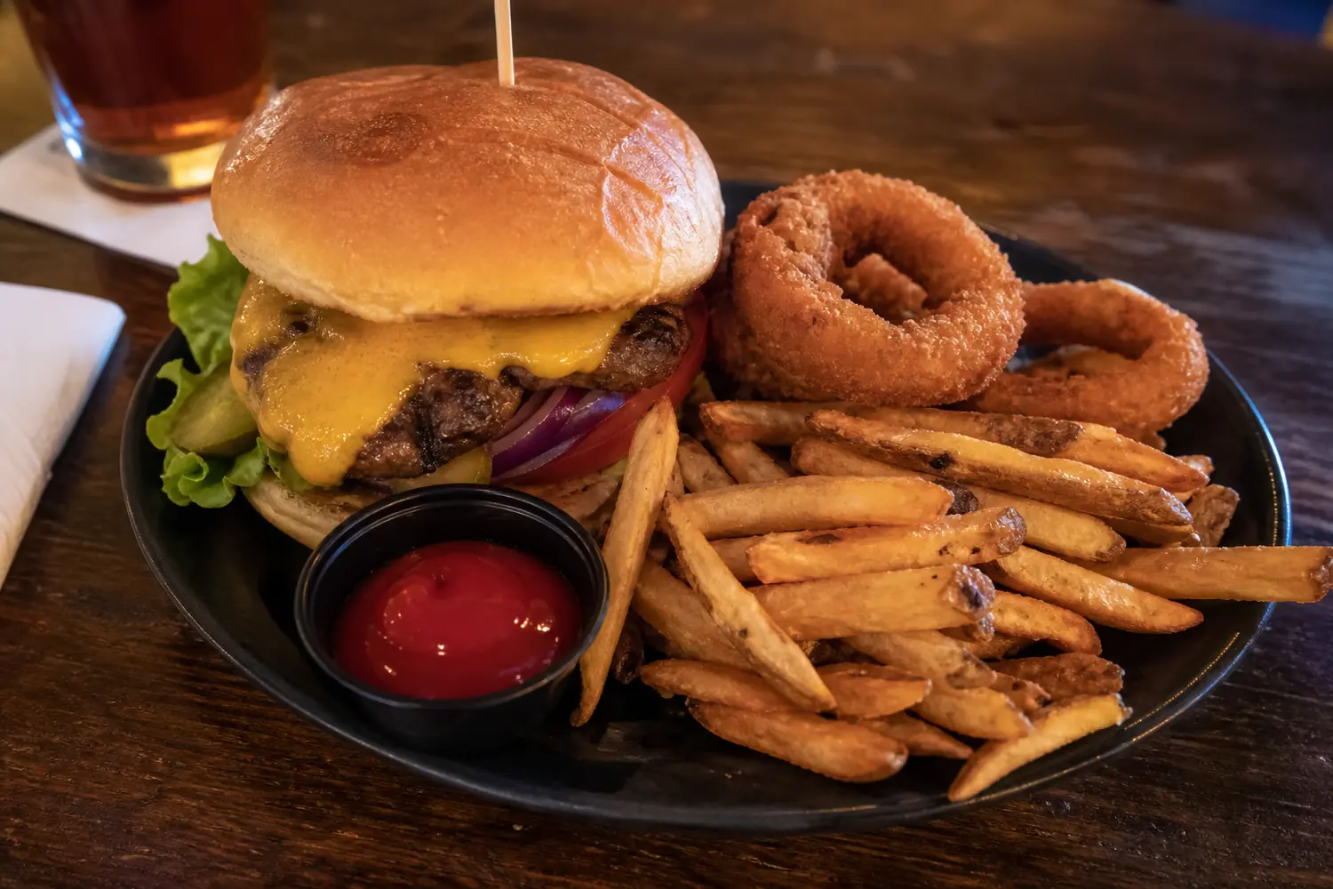 Burger, fries, onion rings, and sauce
